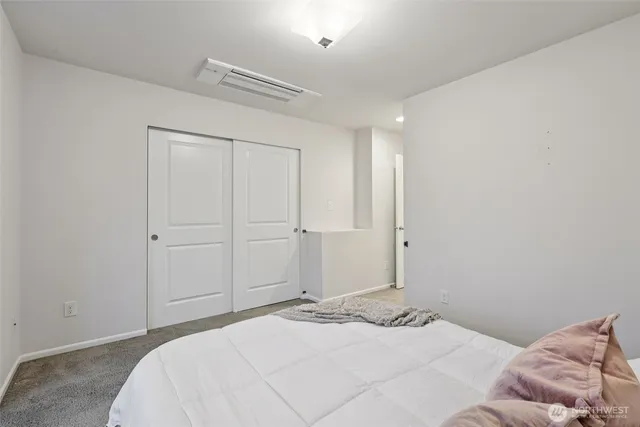 a bedroom with a bed and a mirror