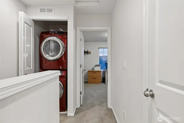 a view of a hallway with washer and dryer