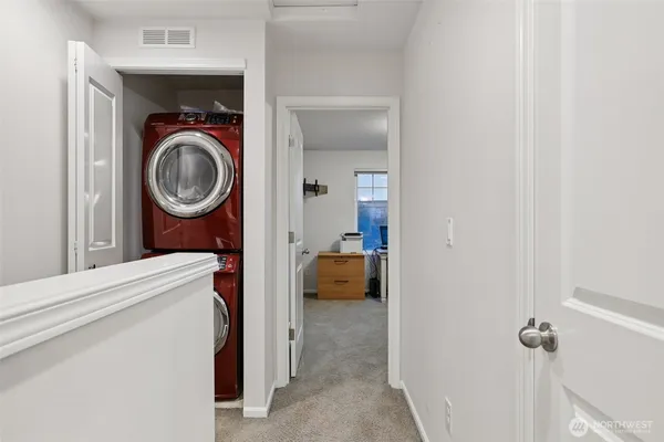 a view of a hallway with washer and dryer