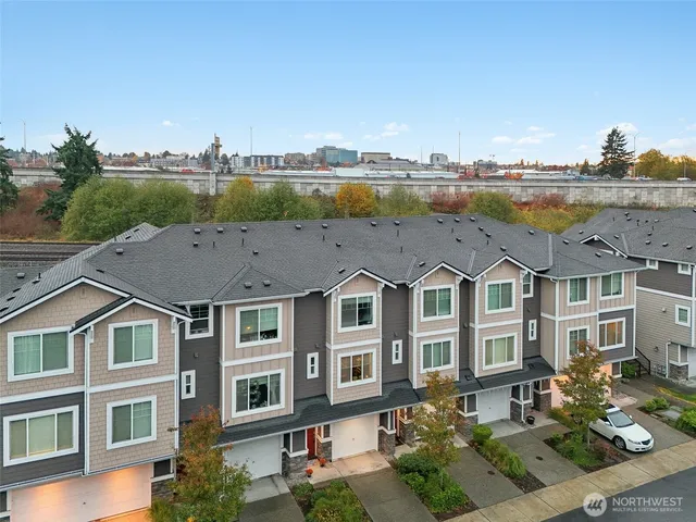 a view of a big house with a big yard and potted plants