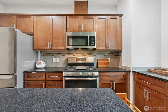a kitchen with wooden cabinets and a stove top oven
