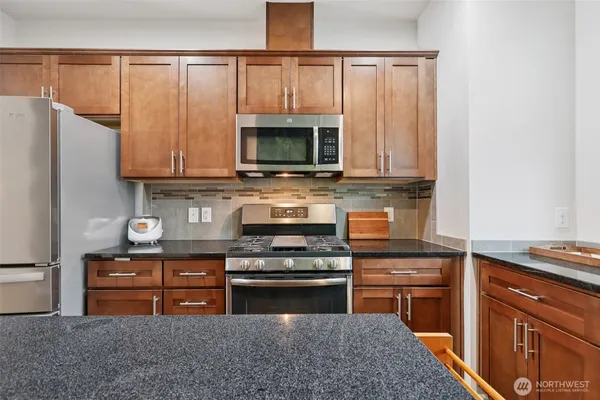 a kitchen with wooden cabinets and a stove top oven