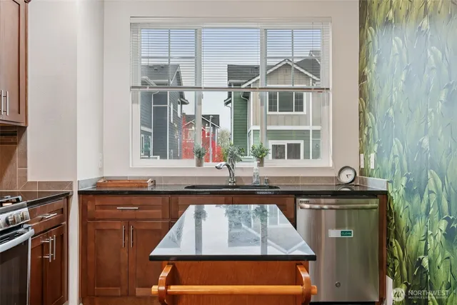 a kitchen with a sink a window and cabinets