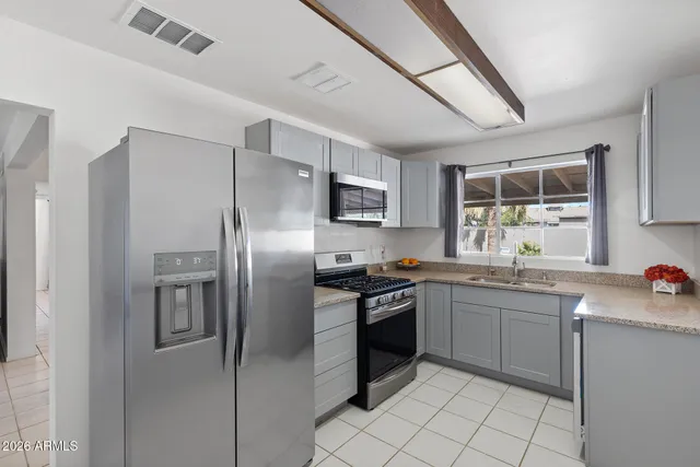 a kitchen with a sink stainless steel appliances and cabinets