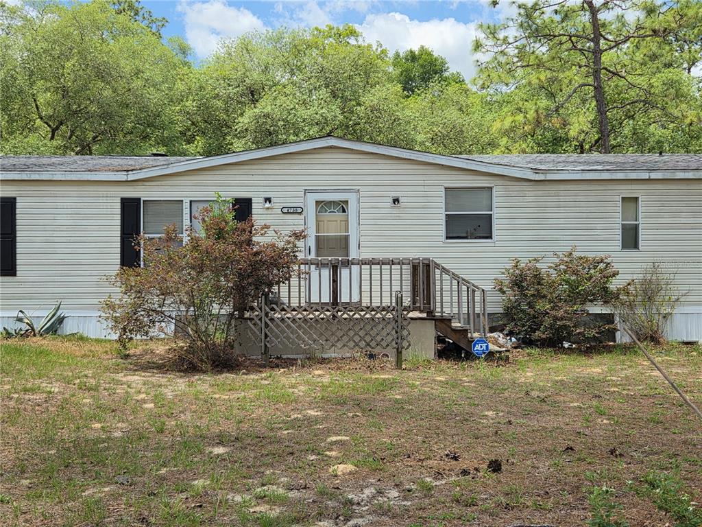 4738 Southwest 166th Court Road Ocala, FL 34481 - Photo 2 of 14 a view of a house with a yard