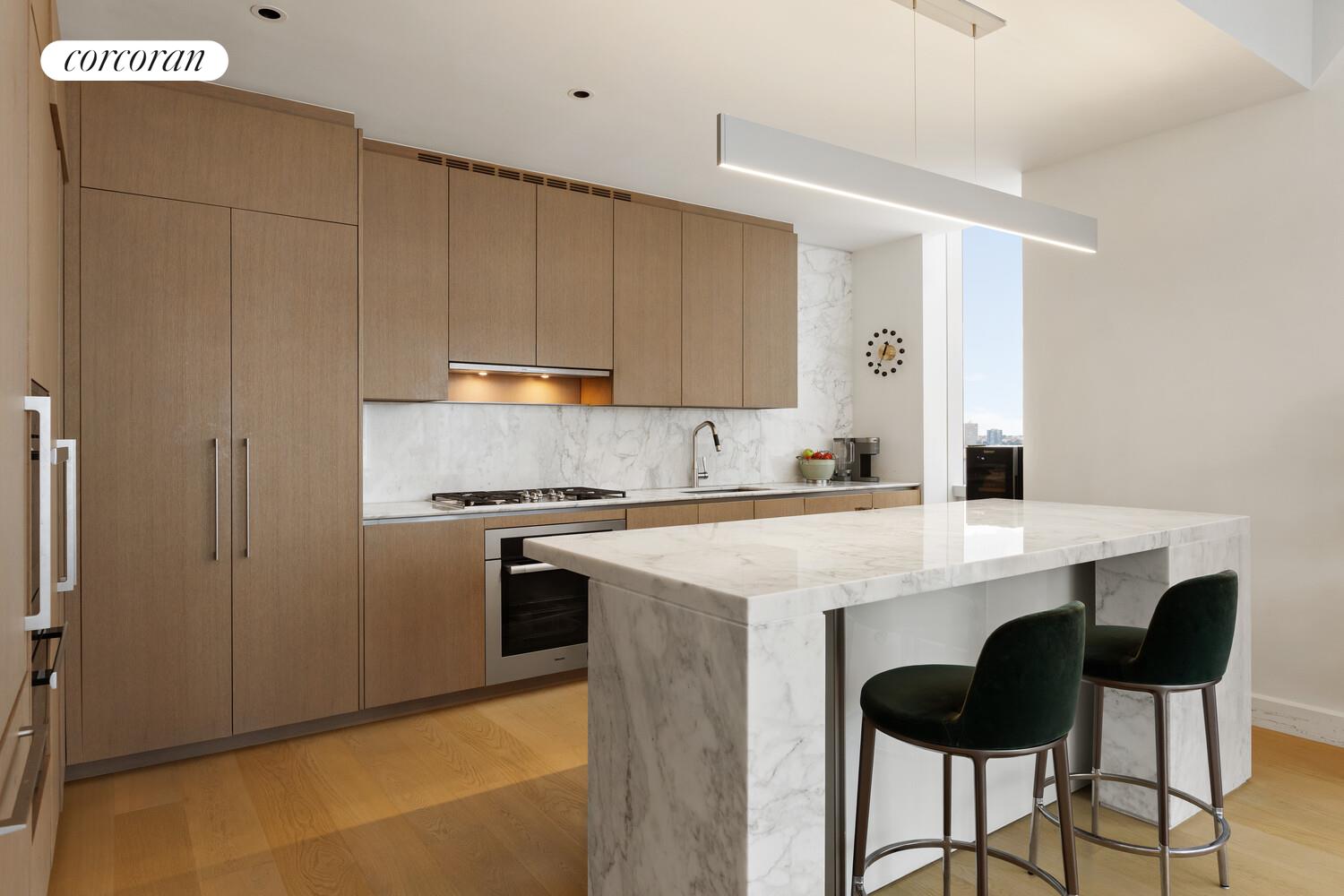 15 Hudson Yards, Unit 25H Manhattan, NY 10001 - Photo 5 of 16 a kitchen with stainless steel appliances a stove a sink refrigerator and a cabinets