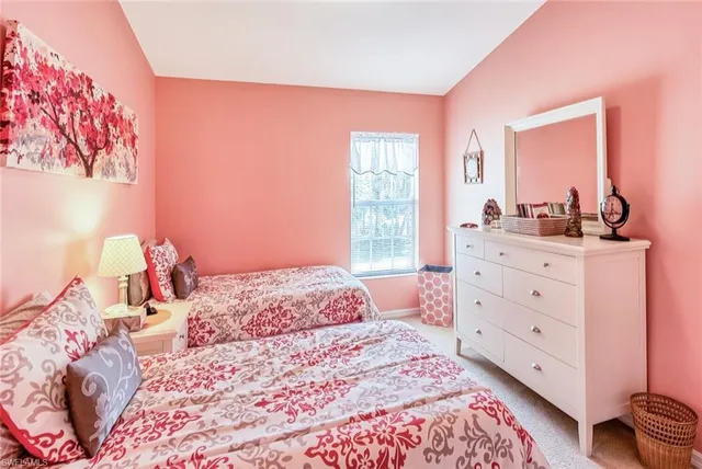 a bedroom with a bed and a dresser in it