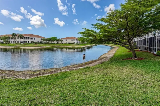 a view of a lake with houses in the back