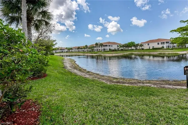 a view of a lake with houses in the back