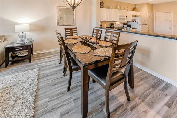 a view of a dining room with furniture and wooden floor