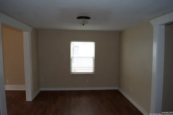 a kitchen with a refrigerator and white cabinets