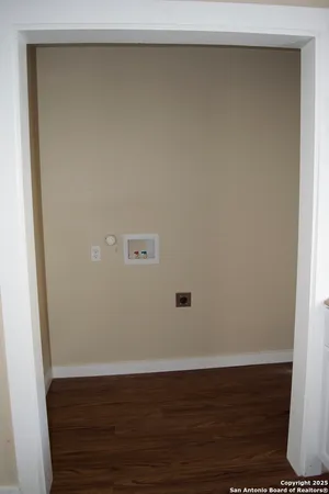 a kitchen with cabinets appliances and a window