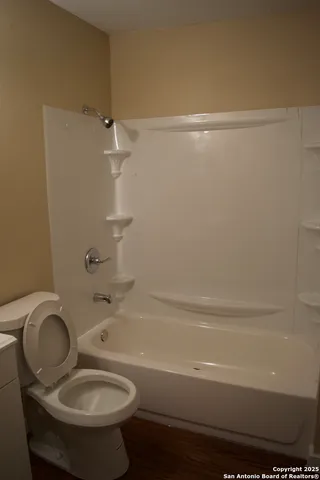 a bathroom with a sink mirror and toilet