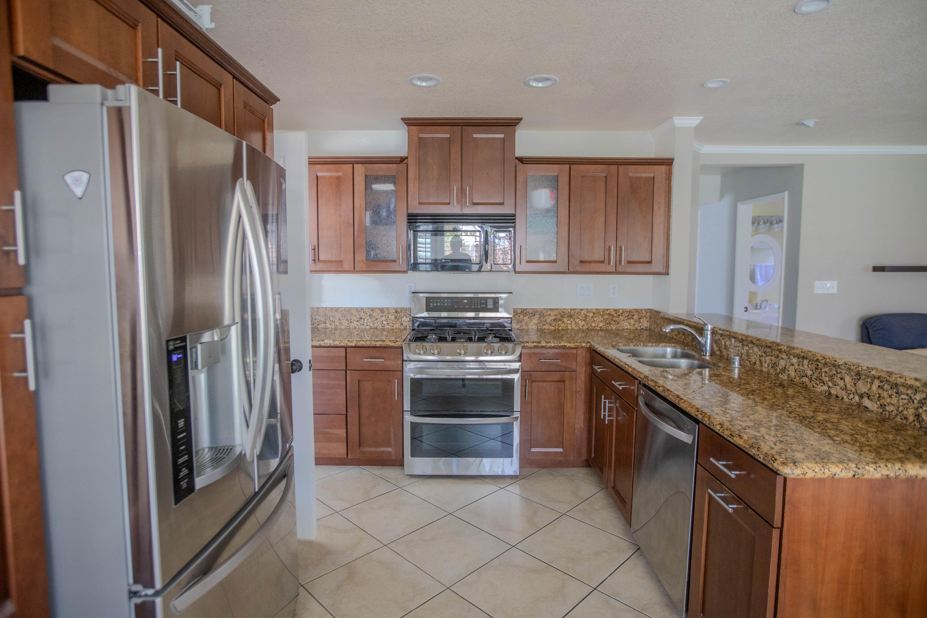36852 Vía Del Rio Palmdale, CA 93550 - Photo 11 of 34 a kitchen with stainless steel appliances granite countertop a stove a refrigerator and a sink