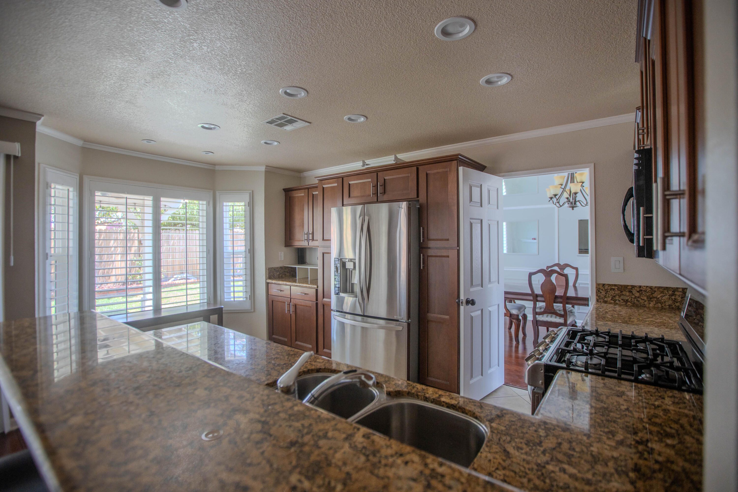36852 Vía Del Rio Palmdale, CA 93550 - Photo 12 of 34 a kitchen with stainless steel appliances granite countertop a refrigerator and a sink