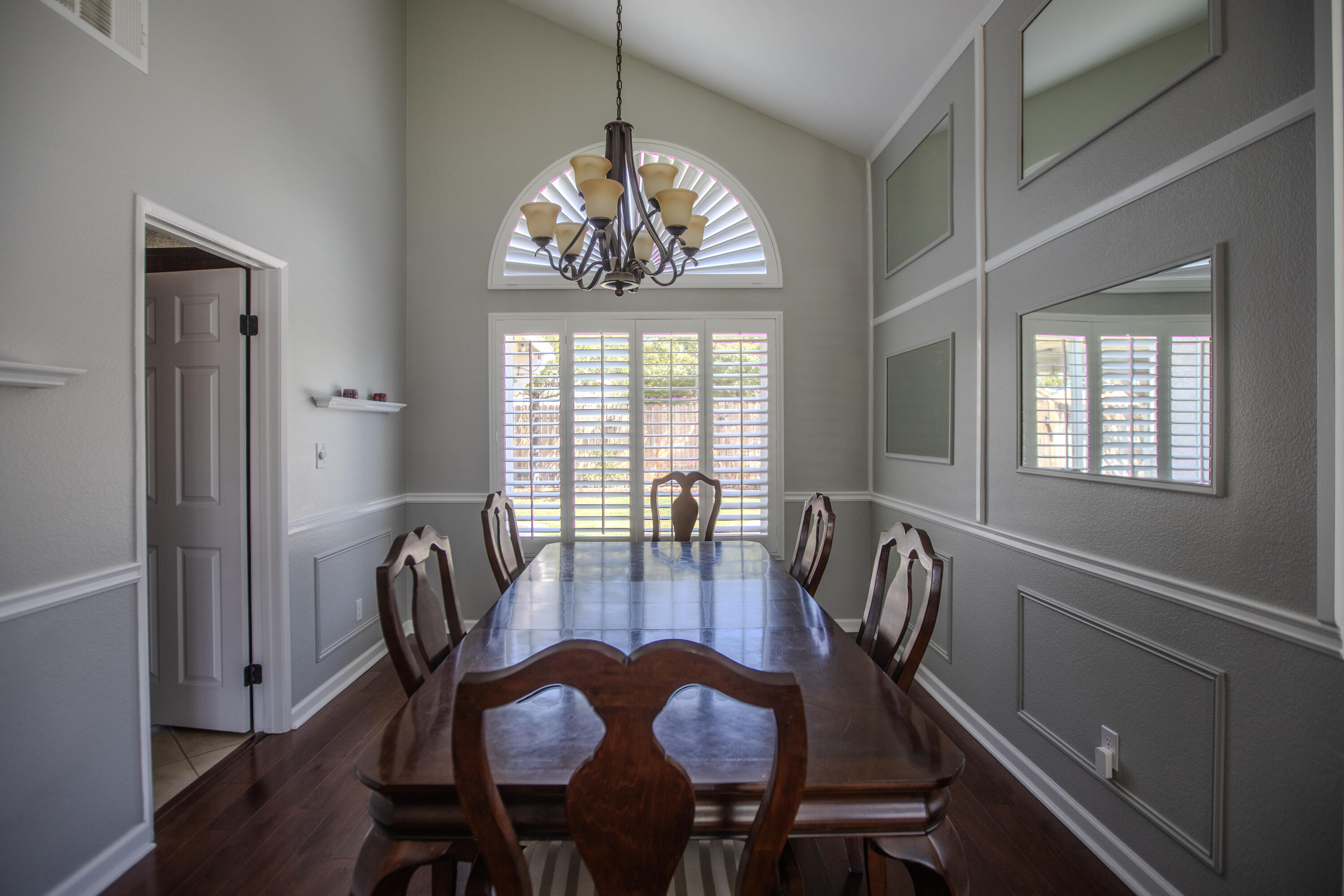 36852 Vía Del Rio Palmdale, CA 93550 - Photo 16 of 34 a view of a dining room with furniture a chandelier and wooden floor