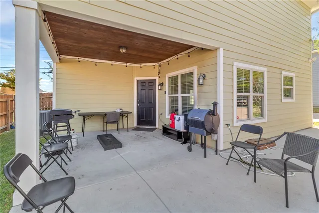 a view of a patio with a table and chairs and potted plants