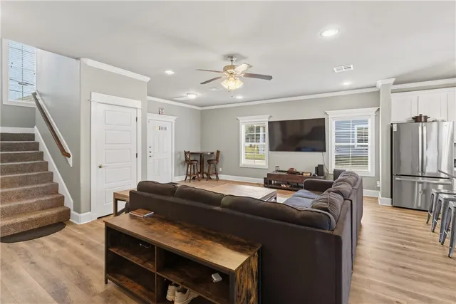 a living room with furniture a flat screen tv and a fireplace