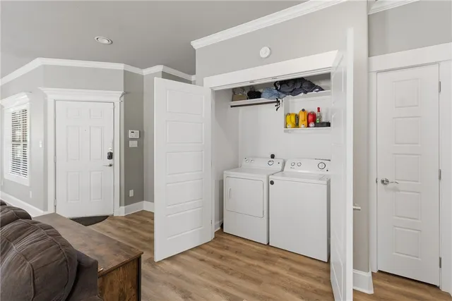 a view of utility room and bedroom with wooden floor