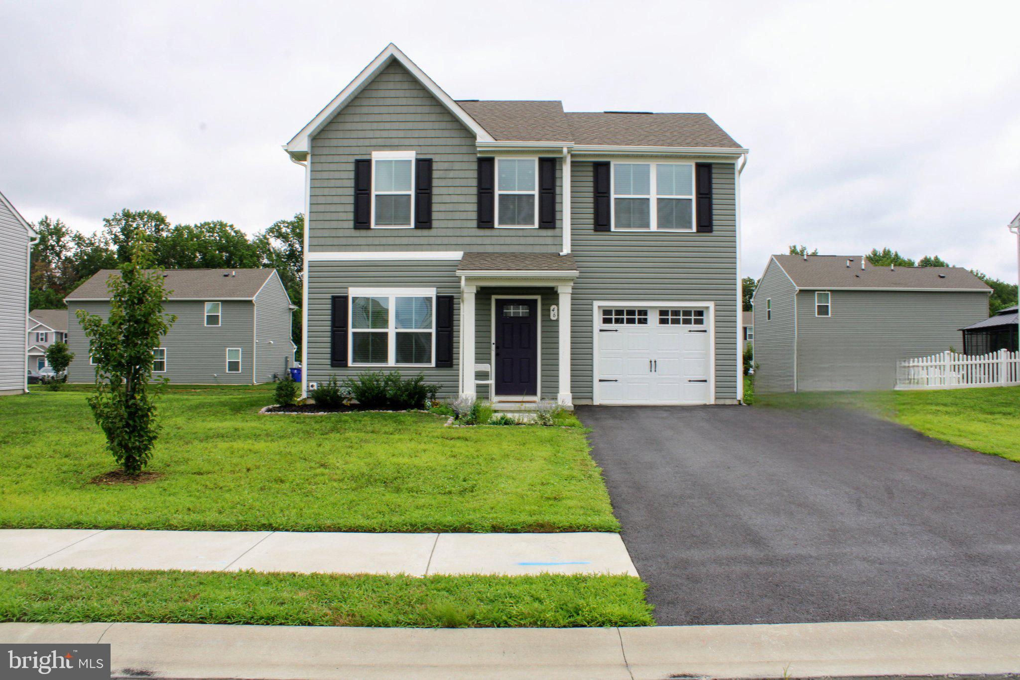 46 Mudstone Road Dover, DE 19904 - Photo 1 of 20 a front view of a house with a yard and garage