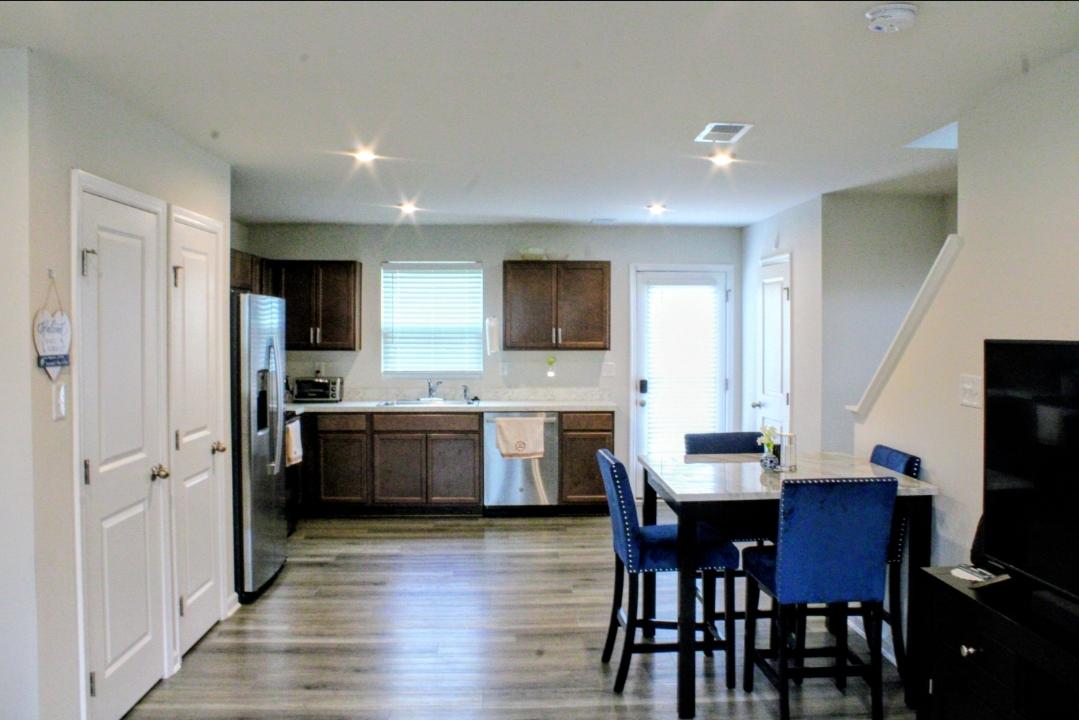 46 Mudstone Road Dover, DE 19904 - Photo 7 of 20 a kitchen with cabinets wooden floor dining table and stainless steel appliances