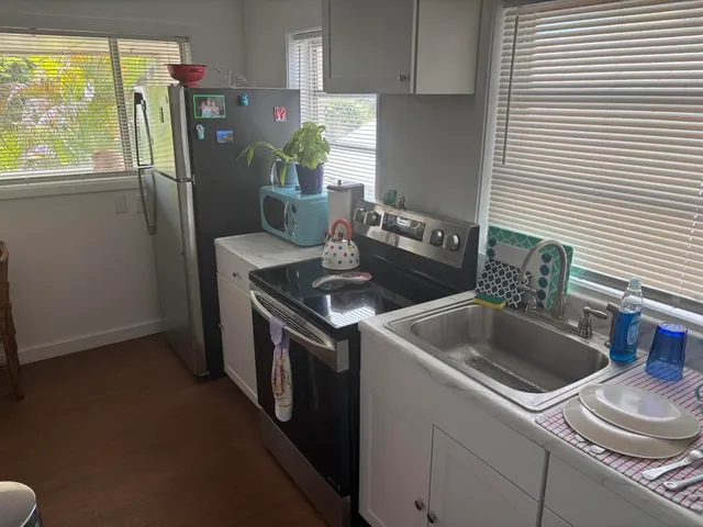 a kitchen that has a sink and a stove