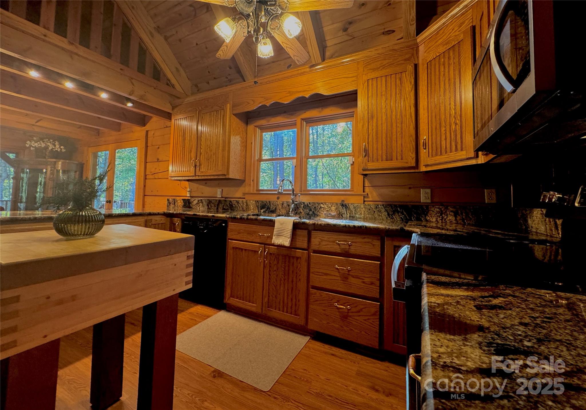 565 Barber Road Gold Hill, NC 28071 - Photo 11 of 42 a kitchen with stainless steel appliances granite countertop a stove a sink dishwasher and cabinets with wooden floor