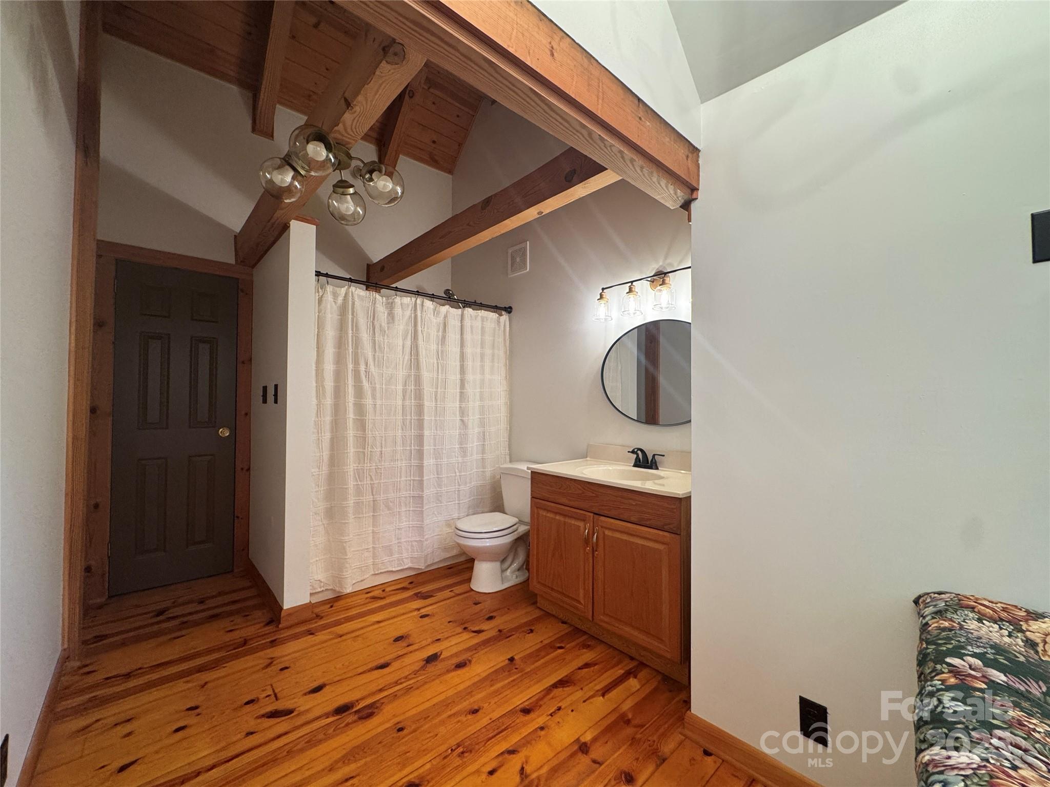 565 Barber Road Gold Hill, NC 28071 - Photo 28 of 42 a bedroom with a bed and a chandelier