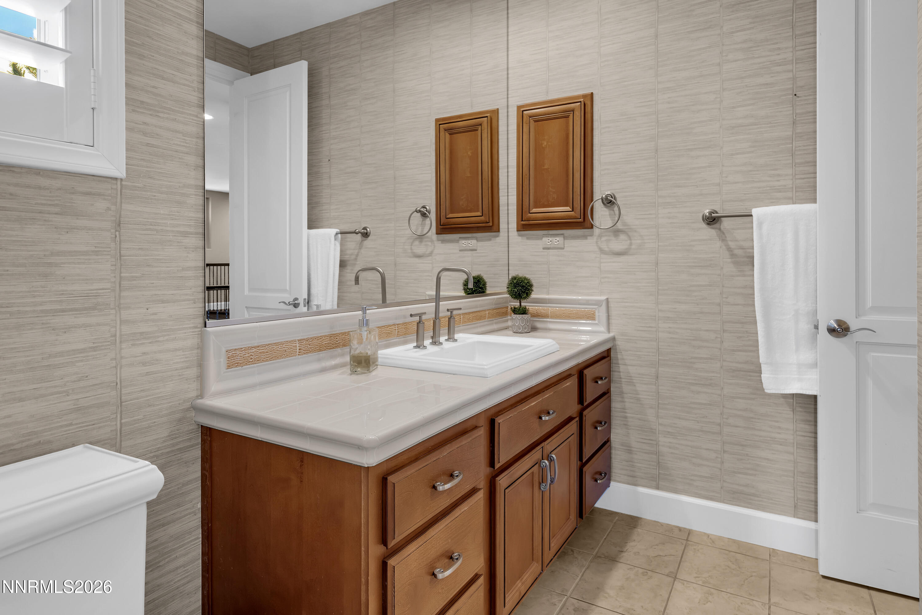 1898 Laurel Ridge Drive Reno, NV 89523 - Photo 62 of 87 a bathroom with a granite countertop sink and a mirror