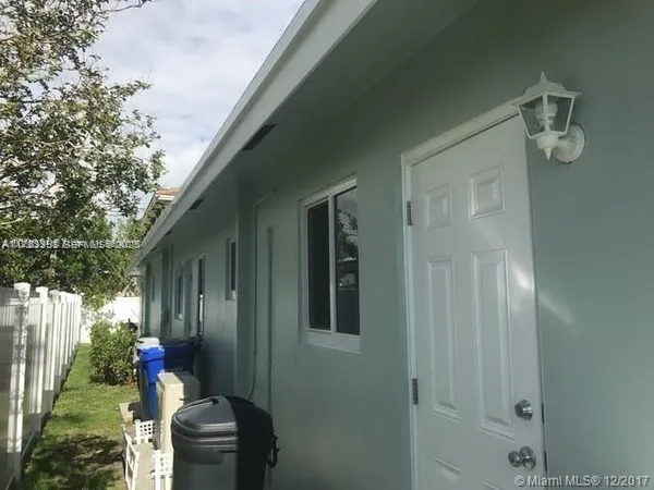 a backyard of a house with outdoor seating