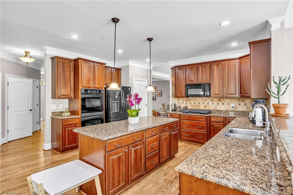 6410 Ashton Park Drive Oak Ridge, NC 27310 - Photo 15 of 49 Kitchen with double oven, built in MW, gas cook top, granite countertops.