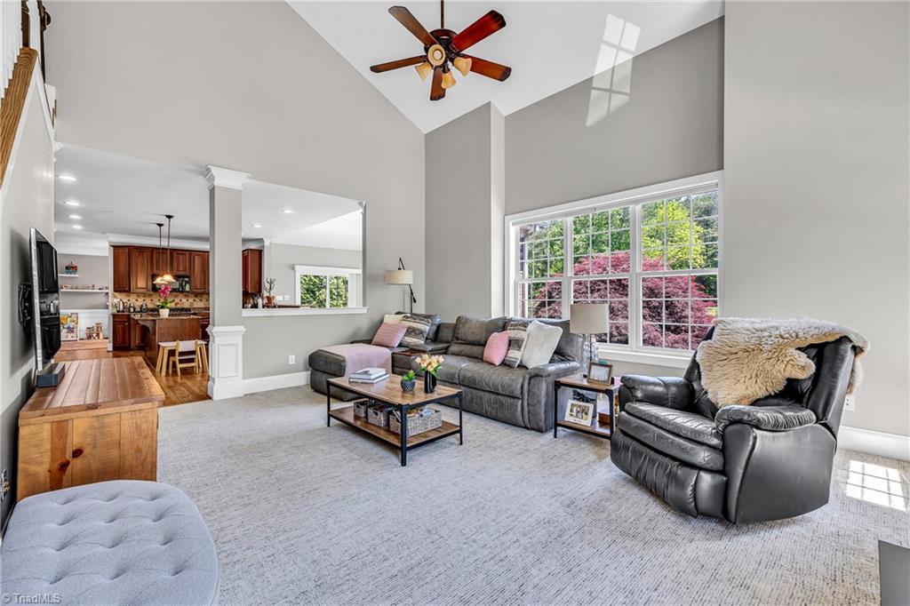6410 Ashton Park Drive Oak Ridge, NC 27310 - Photo 19 of 49 Great room with carpet and vaulted ceiling. Tons of natural light.
