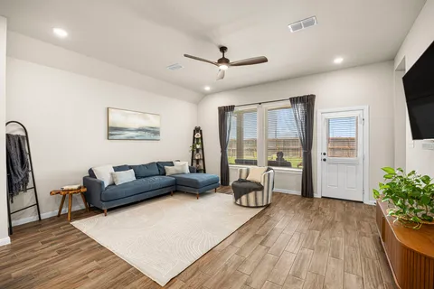 a living room with furniture and a flat screen tv