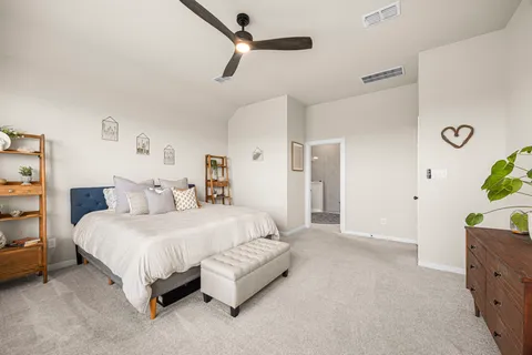 a spacious bedroom with a bed and a dresser