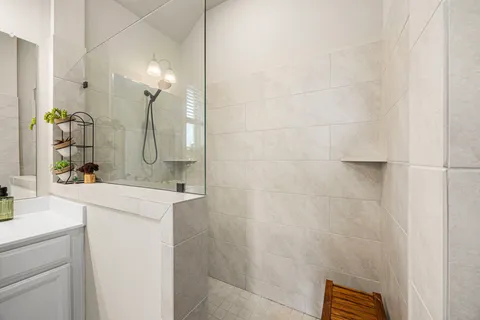 a bathroom with a sink vanity and a mirror