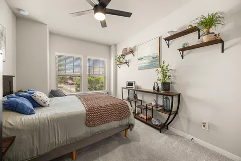a bedroom with a bed and a potted plant