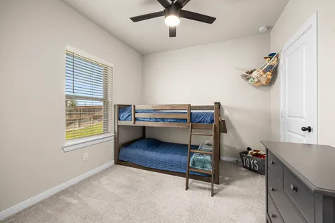 a bedroom with bed and a window