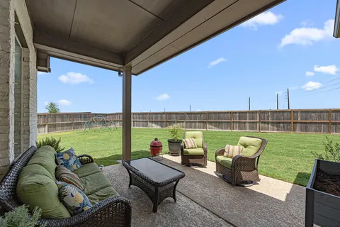 a balcony with furniture and a garden