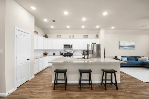 a kitchen with counter space and chairs in it