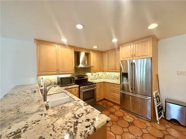 a kitchen with a refrigerator sink and stove