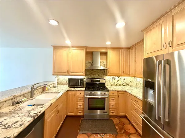 a kitchen with a stove a sink and a refrigerator