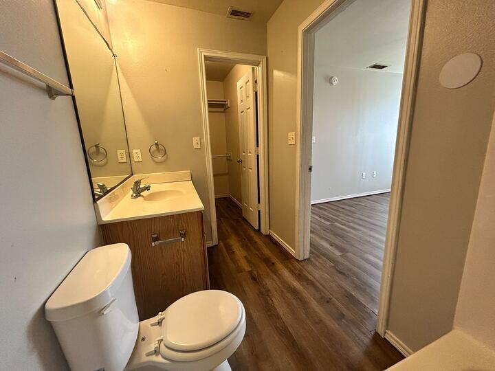 1116 82nd Street, Unit B Lubbock, TX 79423 - Photo 12 of 13 a bathroom with a toilet a sink and mirror