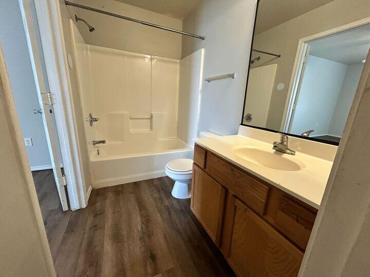1116 82nd Street, Unit B Lubbock, TX 79423 - Photo 13 of 13 a bathroom with a sink a toilet a tub and shower