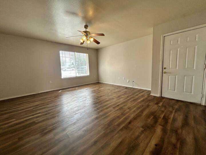 1116 82nd Street, Unit B Lubbock, TX 79423 - Photo 2 of 13 a view of an empty room with a window and wooden floor