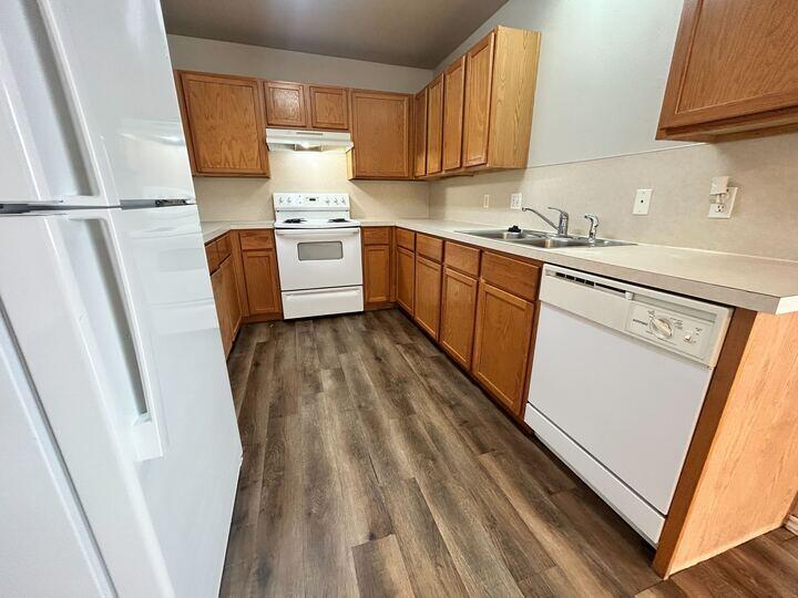 1116 82nd Street, Unit B Lubbock, TX 79423 - Photo 5 of 13 a kitchen with white cabinets and white appliances