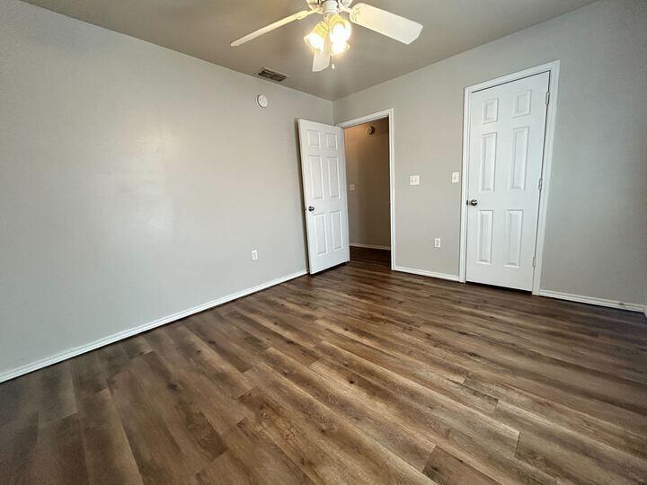 1116 82nd Street, Unit B Lubbock, TX 79423 - Photo 7 of 13 wooden floor in an empty room