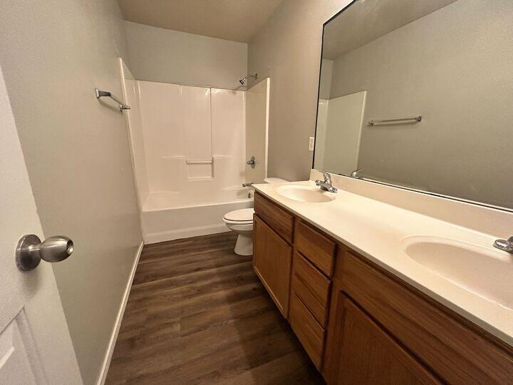 1116 82nd Street, Unit B Lubbock, TX 79423 - Photo 9 of 13 a bathroom with a sink a toilet a shower and a mirror