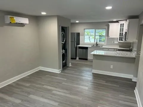 a kitchen with stainless steel appliances granite countertop a refrigerator and a stove top oven