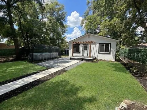 a front view of house with yard and green space