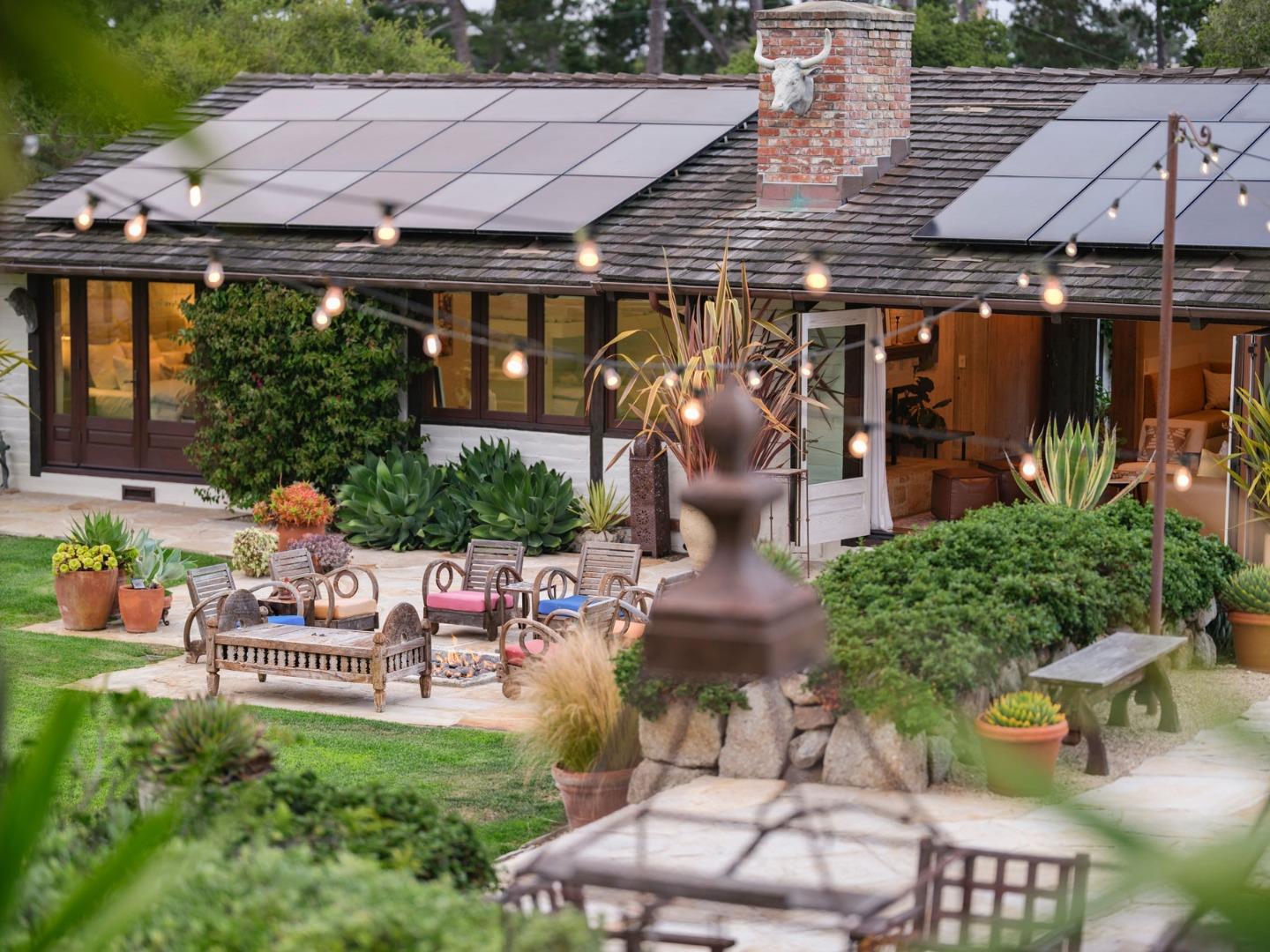1340 Jacks Road Monterey, CA 93940 - Photo 21 of 37 an outdoor sitting area with a table and chairs under an umbrella